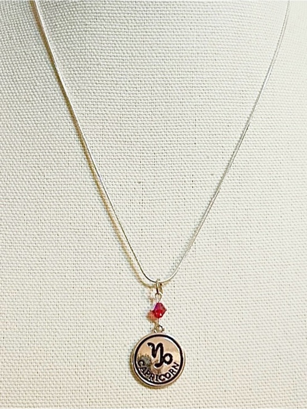 Capricorn Zodiac Pendant Necklace with Red Crystal